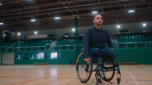Person in wheelchair inside a sports hall