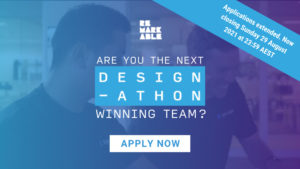 Background image that has been edited with a blue filter featuring 2 men working at a desk smiling. At the top of the image is a white Remarkable logo and underneath is white, large, centred text that reads 'Are you the next Design-athon winning team?' At the bottom of the image is a white rectangle including the blue text 'APPLY NOW'. Applications extended. Now closing Sunday 29 August 2021 at 23:59 AEST
