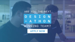 Background image that has been edited with a blue filter featuring 2 men working at a desk smiling. At the top of the image is a white Remarkable logo and underneath is white, large, centred text that reads 'Are you the next Design-athon winning team?' At the bottom of the image is a white rectangle including the blue text 'APPLY NOW'.